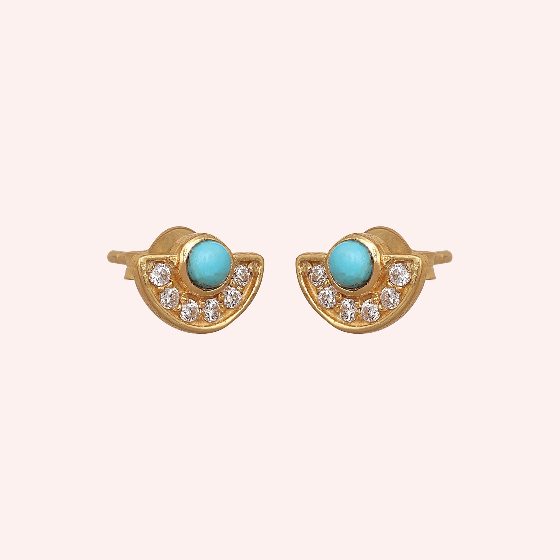 Turquoise_earrings_in_gold_plated_silver_with_turquoise_and_CZ_stones_at_slight_angle_view_on_solid_pink_background