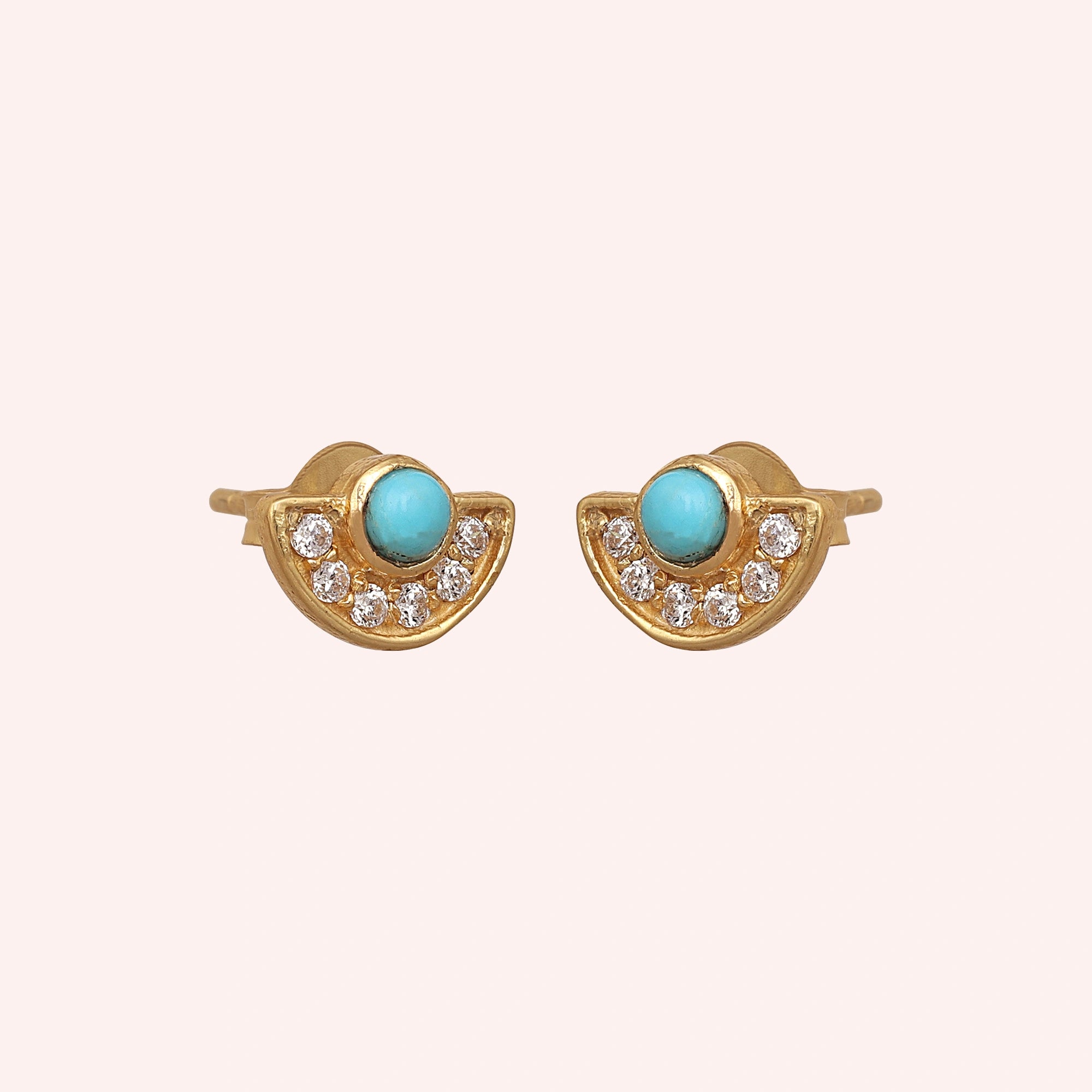 Turquoise_earrings_in_gold_plated_silver_with_turquoise_and_CZ_stones_at_slight_angle_view_on_solid_pink_background