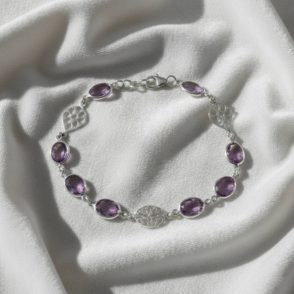 vintage_amethyst_bracelet_top_angle_oval_purple_gemstones_amethyst_tennis_bracelet_in_sterling_silver_on_white_silk_background