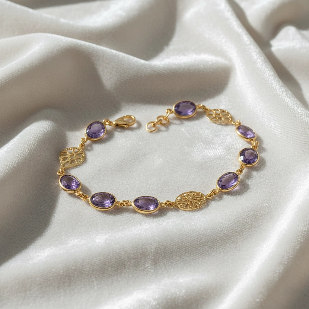 vintage_amethyst_bracelet_top_angle_gold_plated_oval_purple_gemstones_amethyst_tennis_bracelet_on_white_silk_background