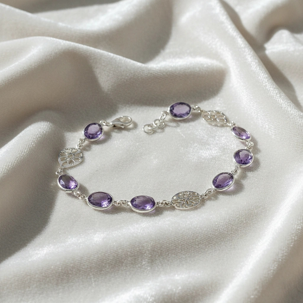 vintage_amethyst_bracelet_top_angle_oval_purple_gemstones_amethyst_tennis_bracelet_in_sterling_silver_on_white_silk_background