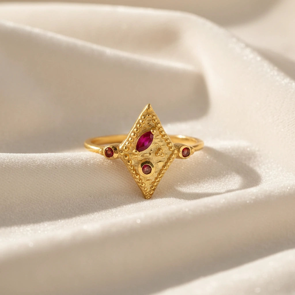Vintage-ring-with-ruby-and-garnet-gemstones-gold-plated-silver-geometric-design-front-view-on-satin-background