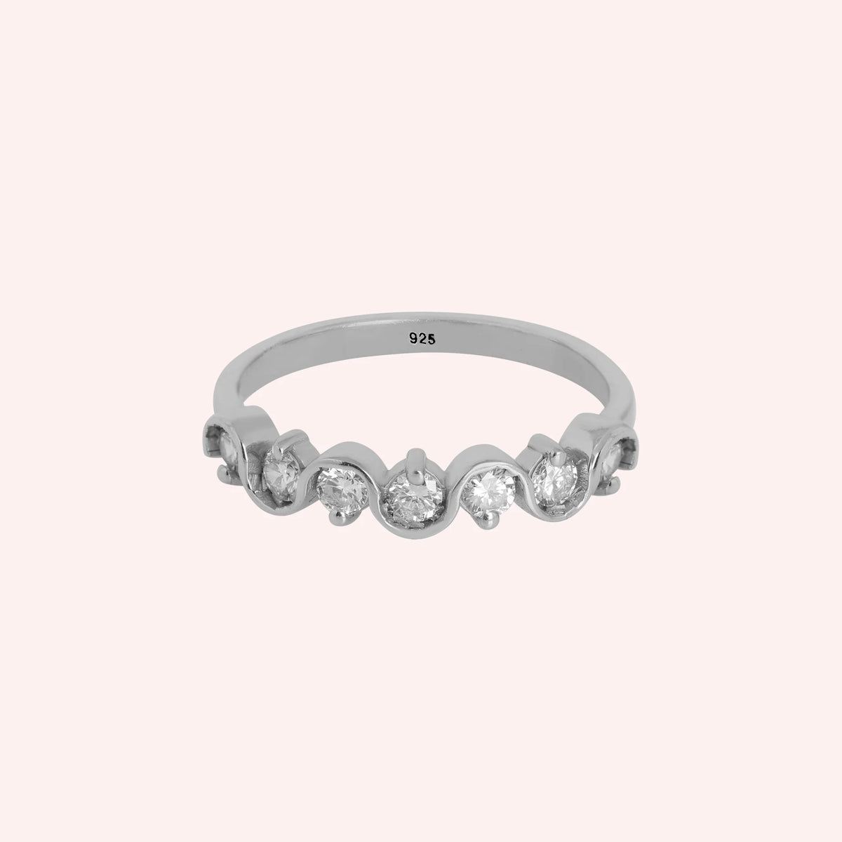 Wave_ring_in_sterling_silver_in_half_eternity_design_with_CZ_stones_at_front_view_on_solid_pink_background