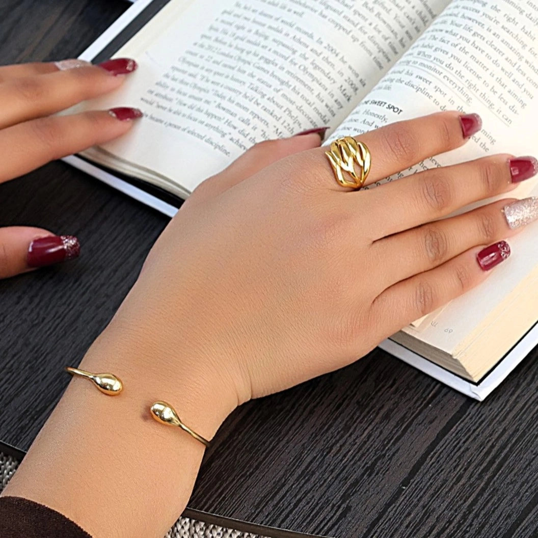 wave ring featuring a flowing silver design as a statement ring over white fabric from a front view angle