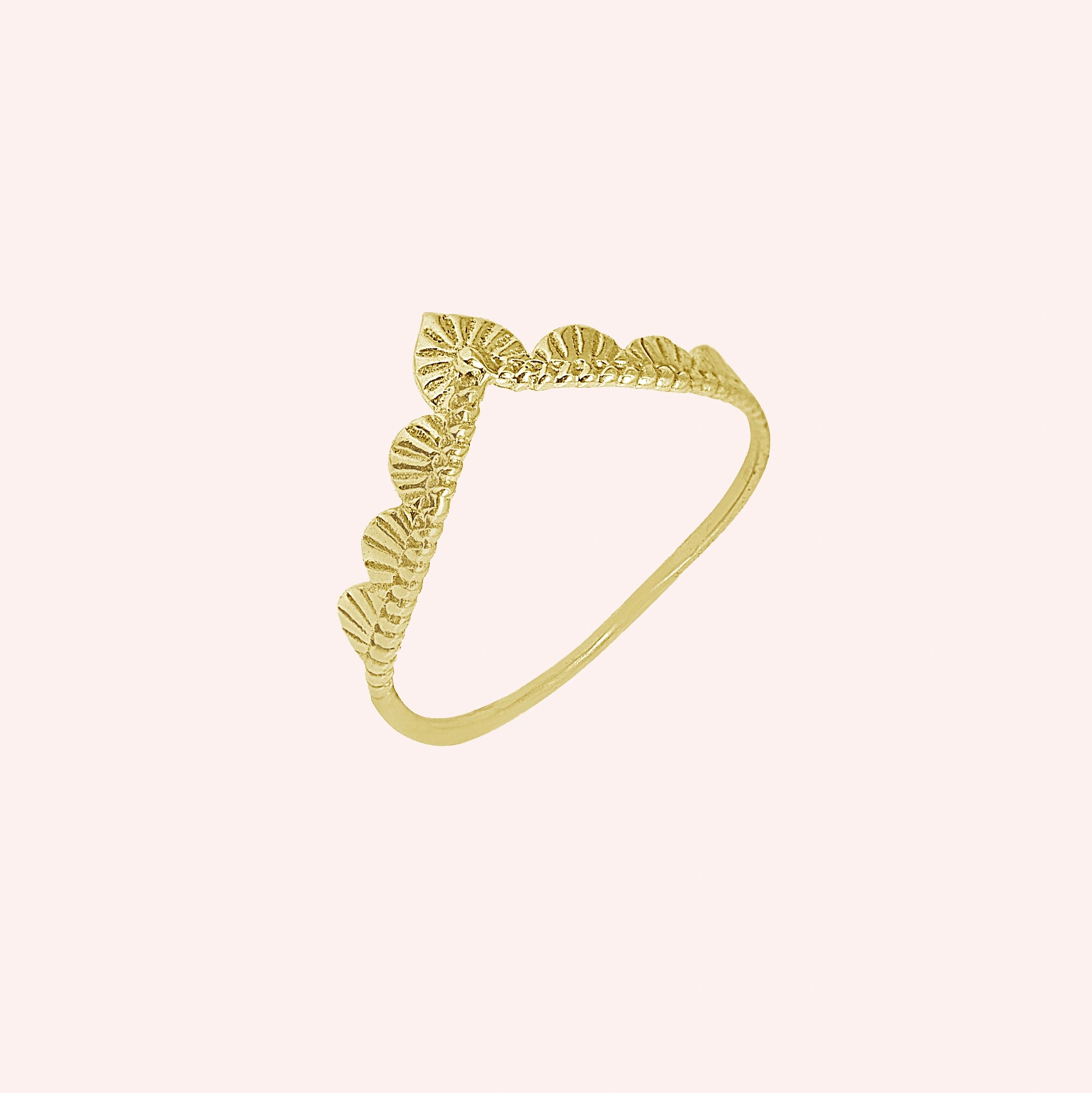 Wishbone_ring_in_gold_plated_silver_with_designed_v_shape_in_slightly_angled_view_on_solid_pink_background