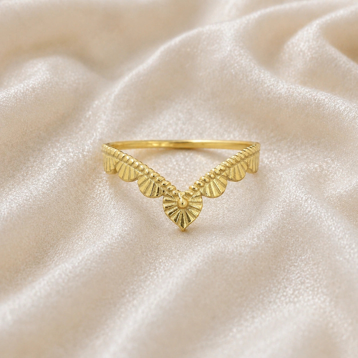 Wishbone_ring_in_gold_plated_silver_with_designed_v_shape_in_front_angle_view_on_soft_fabric_background